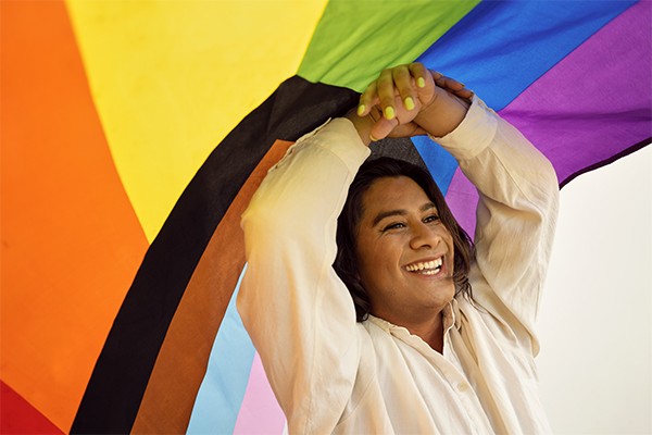 Person smiling under the progress flag